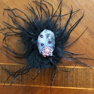 Black feathered fascinated with purple accents